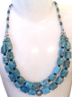 Collier ethnique artisanal deux rangs imitation pierres bleu agencees de pieces argentees ciselees