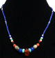 Collier ethnique artisanal imitation perles multicolores agrementees d'une pierre en verre rouge