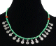 Collier ethnique artisanal imitation perles vertes agrementees de breloques en spiral en metal argente