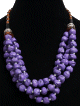 Collier ethniques artisanal imitation pierres mauves trois rangs agrementees de perles en bois et de breloques argentees