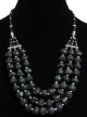 Collier ethnique artisanal trois rangs imitation pierres noires et perles agencees de pieces argentees ciselees