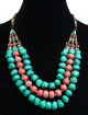 Collier ethnique artisanal trois rangs imitation pierres turquoises et roses agrementees de perles et d'armatures argentees ciselees