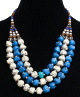 Collier ethnique artisanal imitation pierres blanches, bleues, turquoises trois rangs perles agencees de pieces argentees ciselees