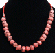 Collier ethnique artisanal imitation pierres rouges agencees de perles rouges et argentees