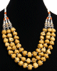 Collier ethnique artisanal trois rangs imitation pierres jaunes et perles agencees de pieces argentees ciselees